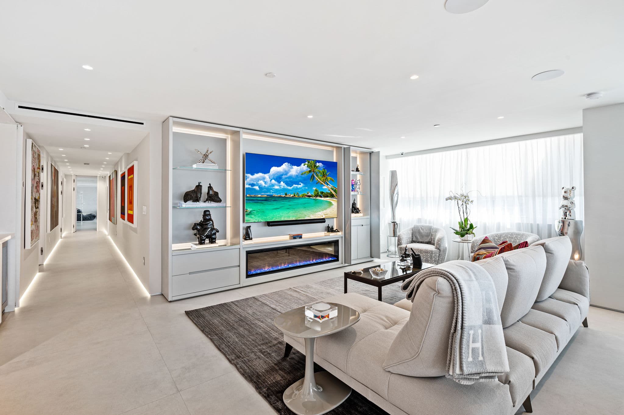 Living room with custom entertainment center and linear fireplace